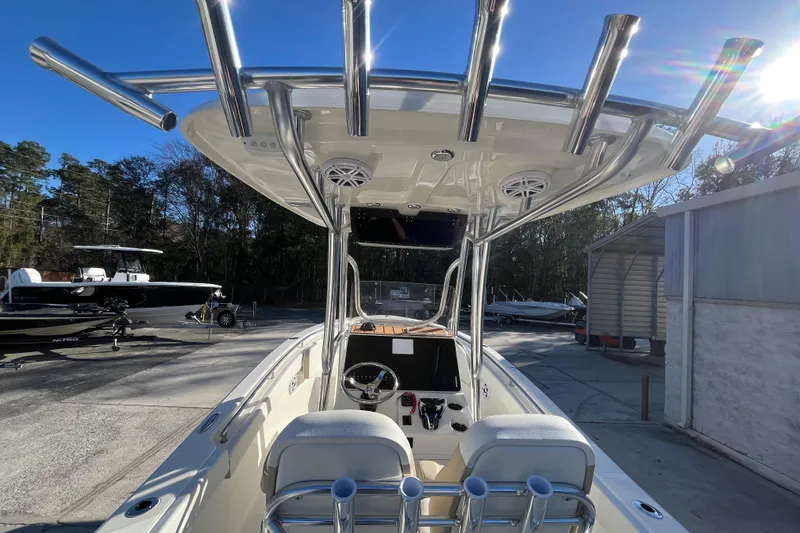 Slide: The Image of 2026 Bulls Bay 255 Center Console boat with T-top and dual seats in a marina. - 16