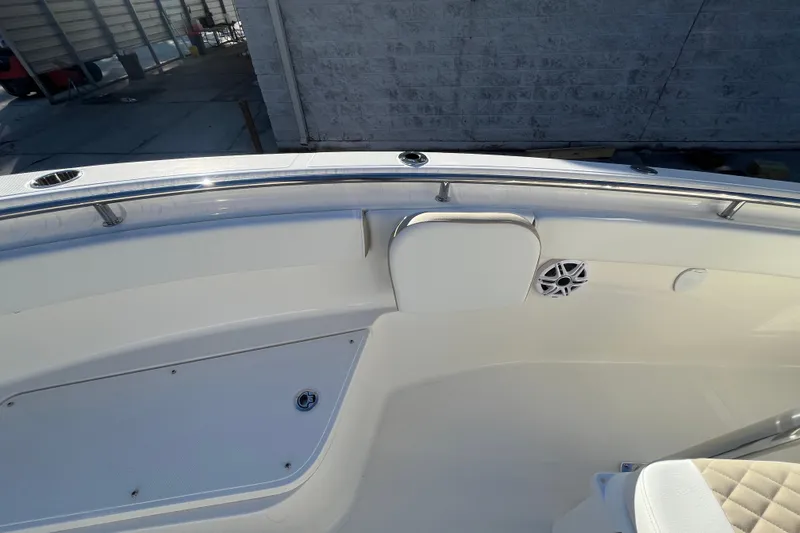 Slide: The Image of 2026 Bulls Bay 255 Center Console boat interior with seating and speaker detail. - 18