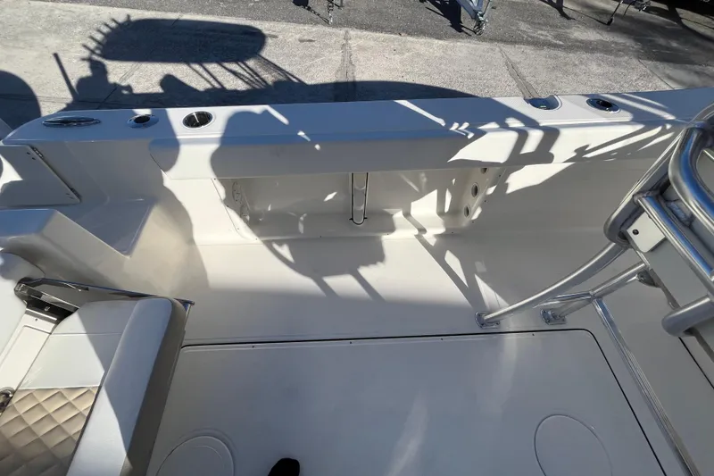 Slide: The Image of 2026 Bulls Bay 255 Center Console boat interior with seating and rod holders. - 19