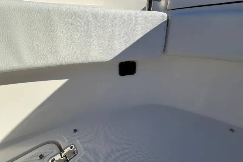 Slide: The Image of Interior detail of 2026 Bulls Bay 255 Center Console boat, featuring white upholstery and hardware. - 28