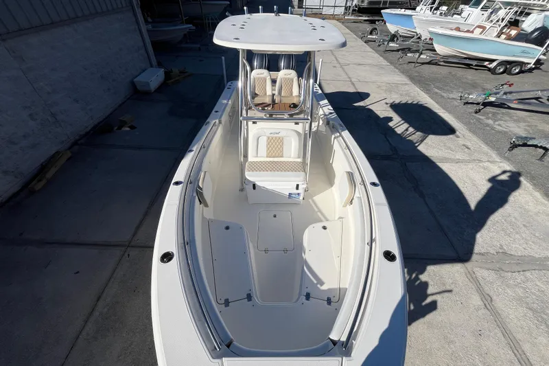 Slide: The Image of 2026 Bulls Bay 255 Center Console boat, docked, showcasing spacious deck and seating. - 7