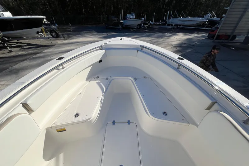 Slide: The Image of 2026 Bulls Bay 255 Center Console boat, spacious deck, parked outdoors. - 9