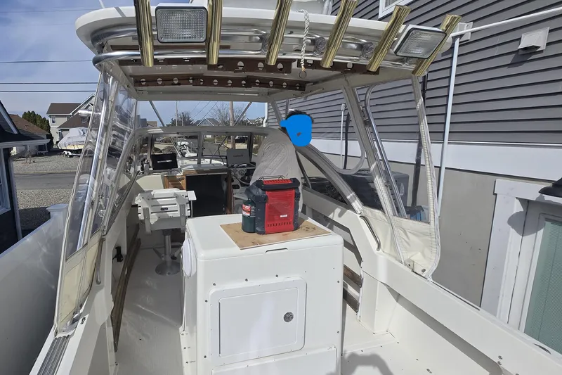 Slide: The Image of 1992 Shamrock 260 Express boat interior with fishing rod holders and navigation equipment. - 10