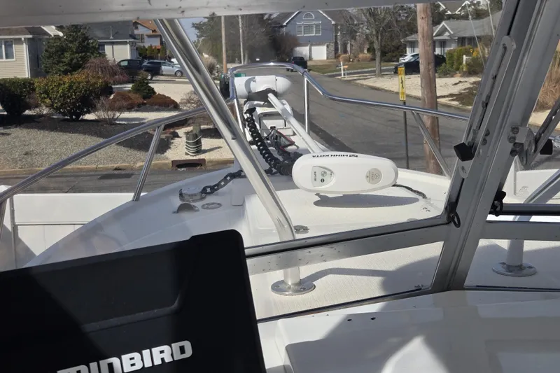 Slide: The Image of 1992 Shamrock 260 Express boat with Minn Kota trolling motor, docked in a residential area. - 11