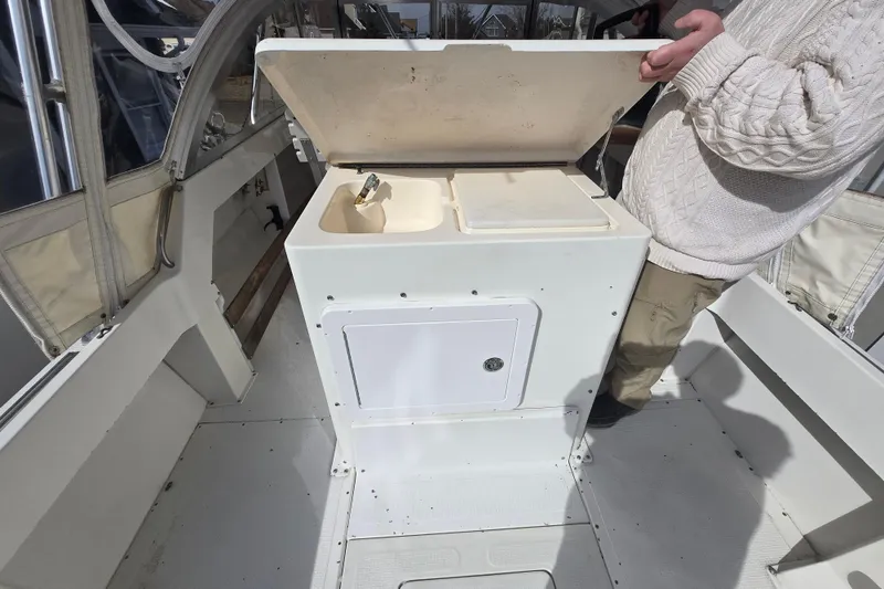 Slide: The Image of 1992 Shamrock 260 Express boat interior with open storage compartment. - 12