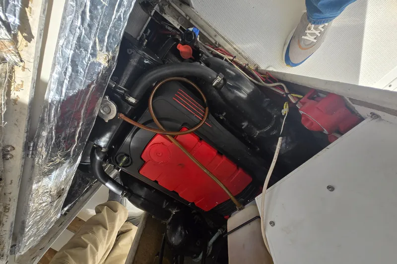 Slide: The Image of Engine compartment of a 1992 Shamrock 260 Express boat, featuring visible components and wiring. - 16