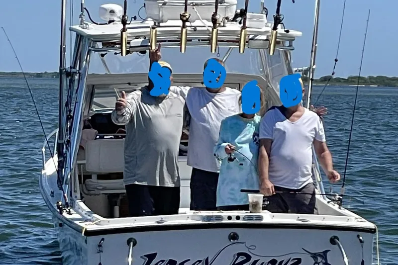 Slide: The Image of Three people on a 1992 Shamrock 260 Express boat, enjoying a fishing trip. - 4