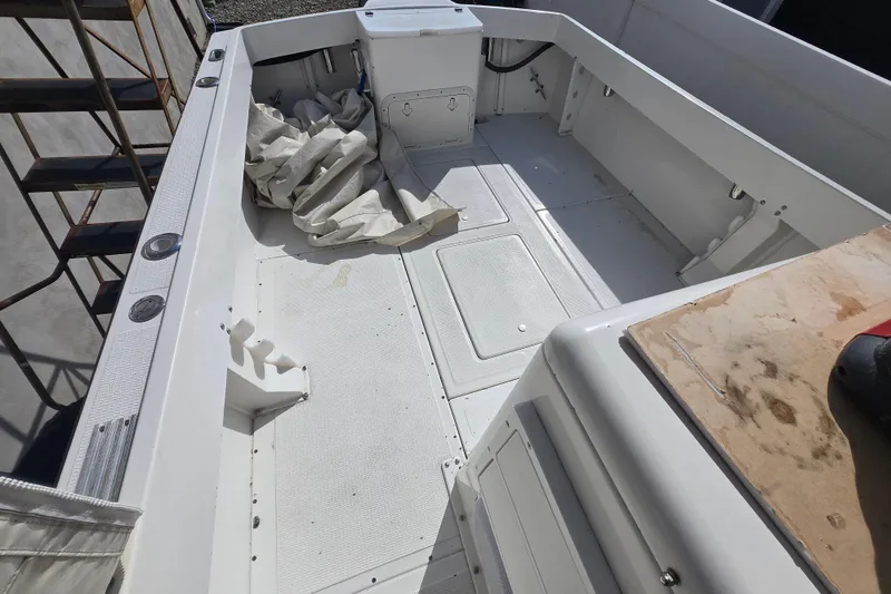 Slide: The Image of 1992 Shamrock 260 Express boat interior, featuring spacious deck and storage compartments. - 9
