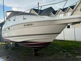 Slide: The Image of 2003 Regal Commodore 2860 boat on dry dock near residential area. - 13