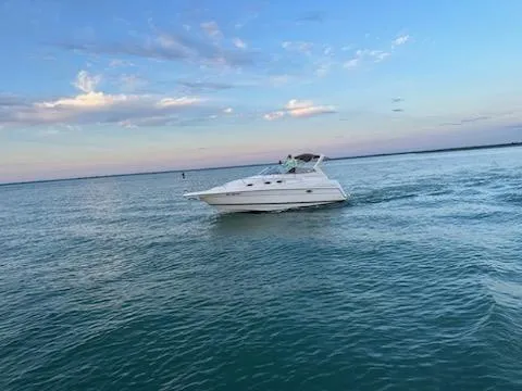 Slide: The Image of 2003 Regal Commodore 2860 boat cruising on calm waters under a blue sky. - 14
