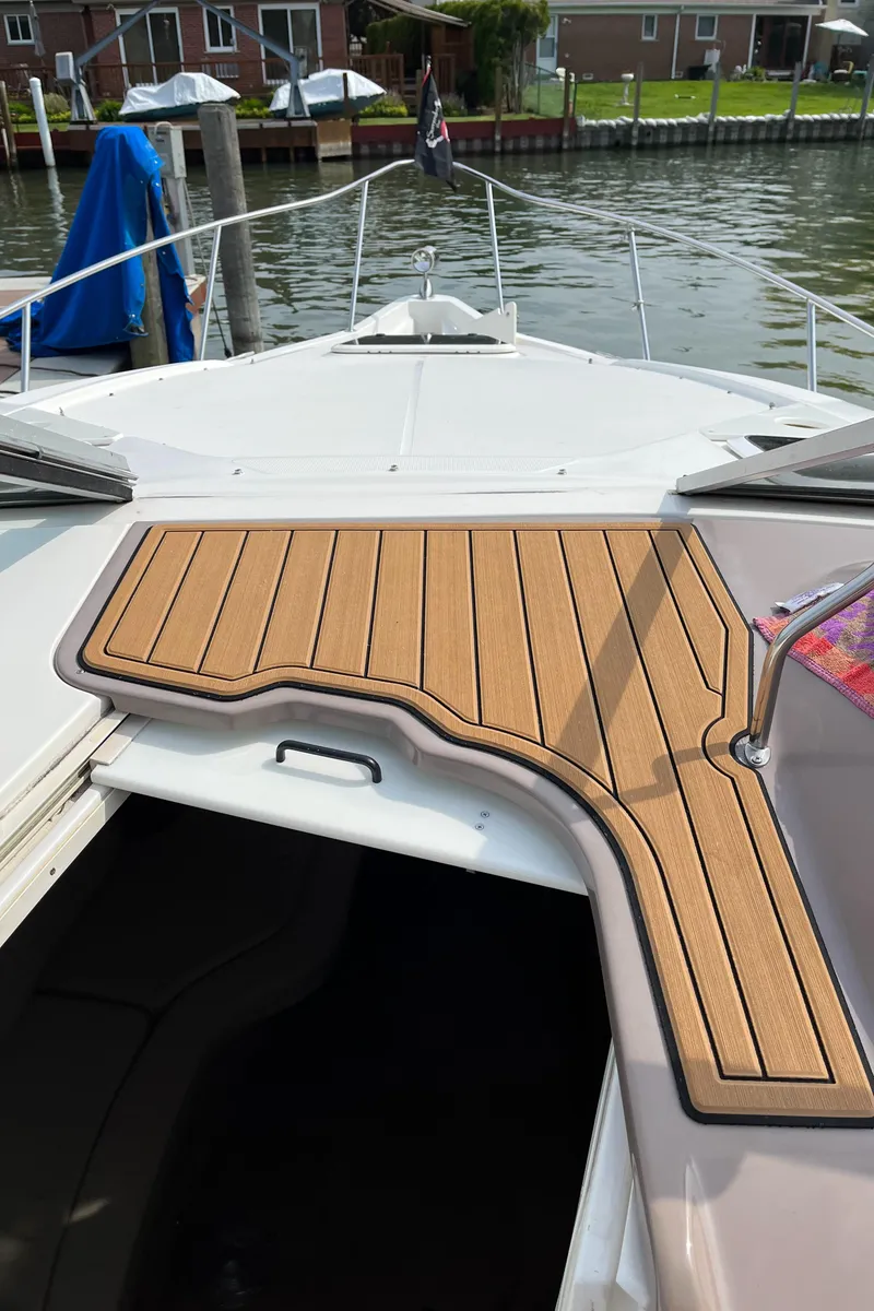 Slide: The Image of 2003 Regal Commodore 2860 boat docked at a marina. - 19