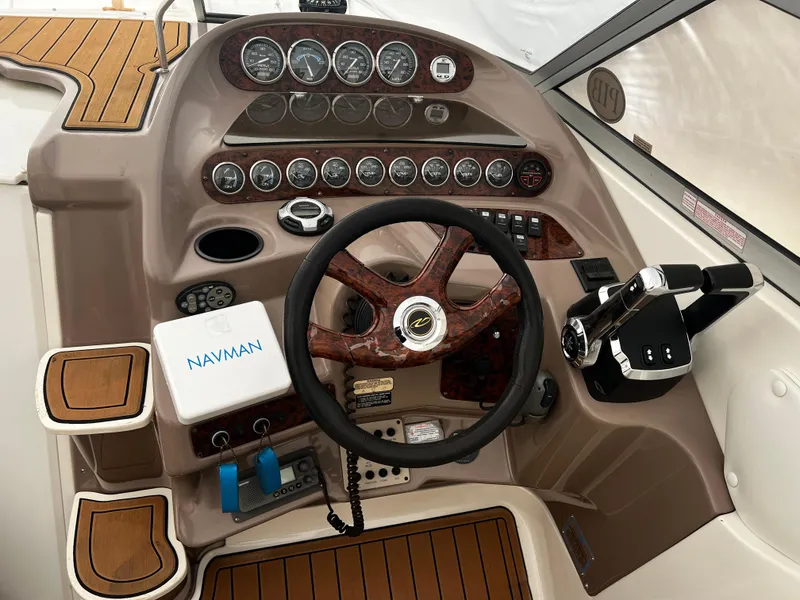 Slide: The Image of 2003 Regal Commodore 2860 boat dashboard with steering wheel and Navman GPS. - 20