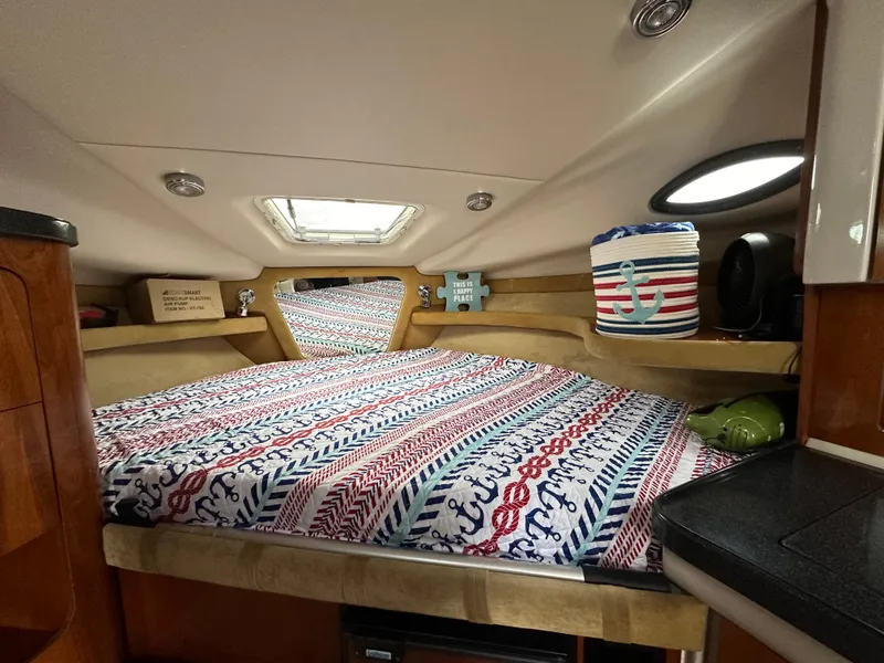 Slide: The Image of 2003 Regal Commodore 2860 cabin interior with nautical-themed bedding. - 23