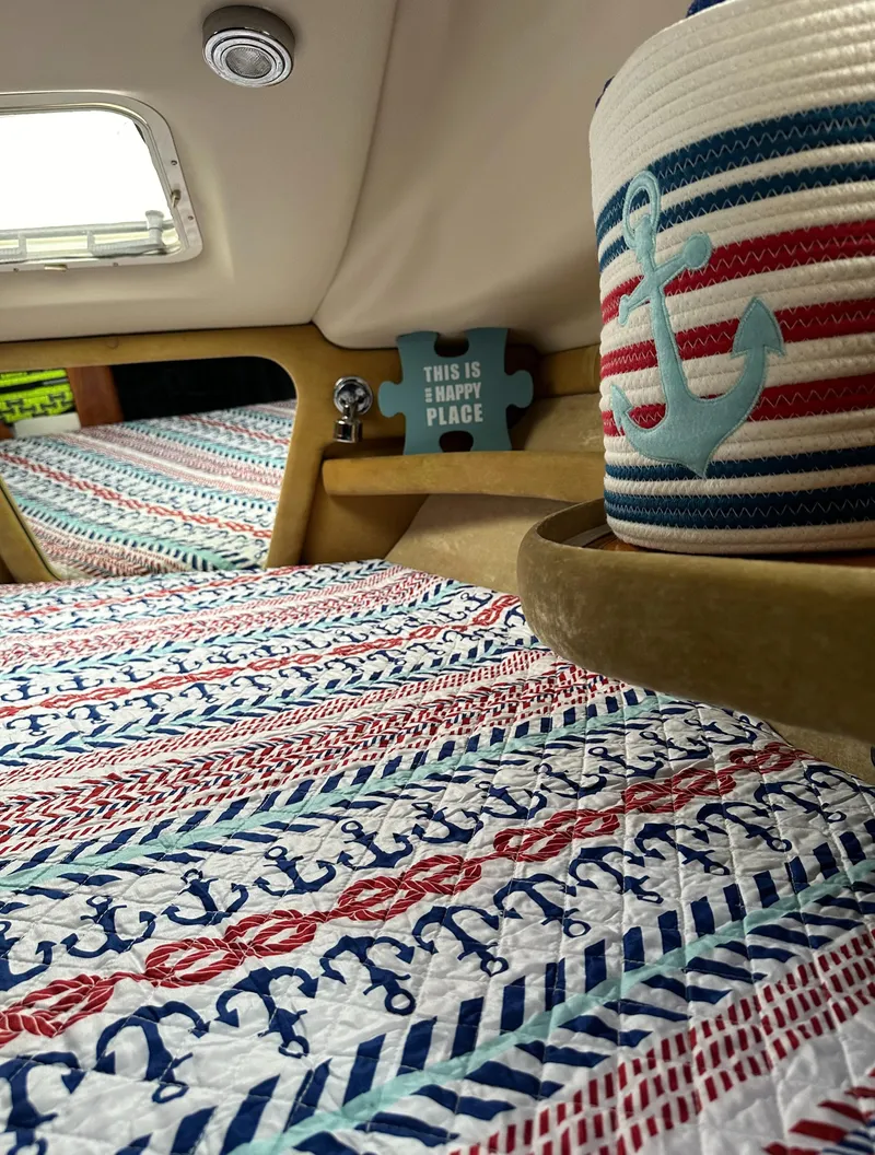 Slide: The Image of Interior of 2003 Regal Commodore 2860 with nautical-themed decor and anchor-patterned bedding. - 25