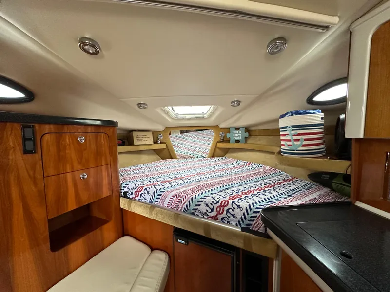 Slide: The Image of Interior cabin of 2003 Regal Commodore 2860 with cozy bed and wooden cabinetry. - 26