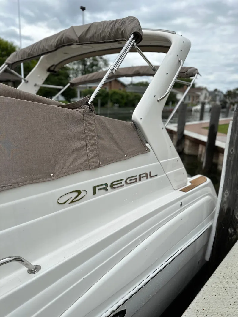Slide: The Image of 2003 Regal Commodore 2860 boat docked at a marina. - 3