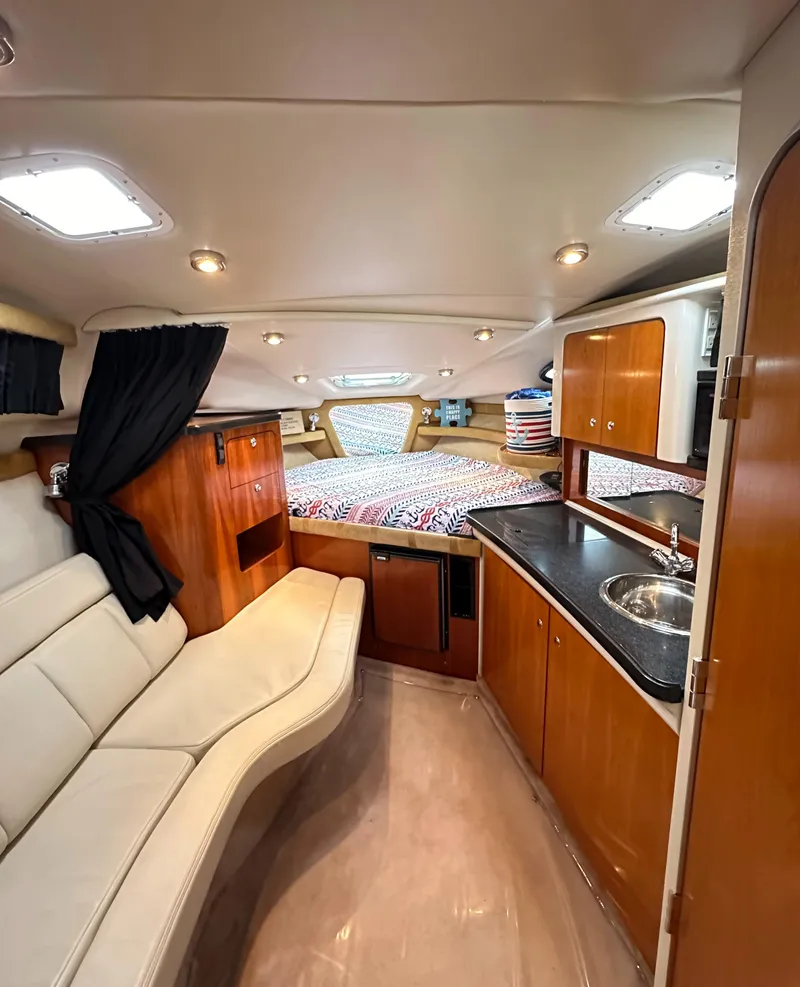 Slide: The Image of Interior of 2003 Regal Commodore 2860 boat with kitchenette, seating, and sleeping area. - 33