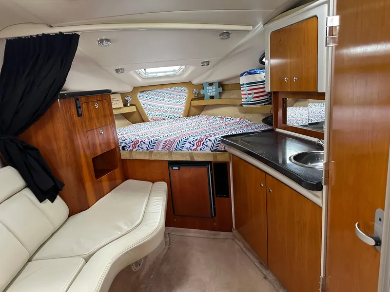 Slide: The Image of Interior of 2003 Regal Commodore 2860 boat with kitchenette, seating, and bed. - 34