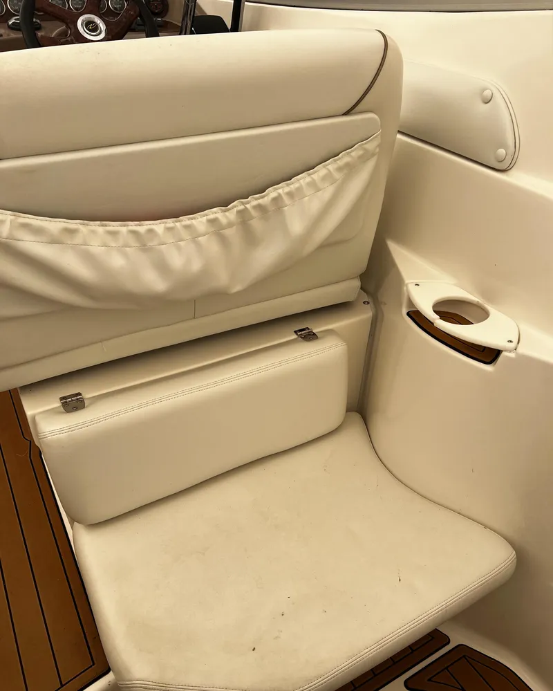 Slide: The Image of 2003 Regal Commodore 2860 boat interior with white leather seating and cup holder. - 37