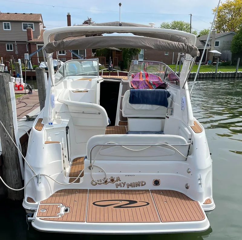 Slide: The Image of 2003 Regal Commodore 2860 boat docked at a marina, rear view. - 4