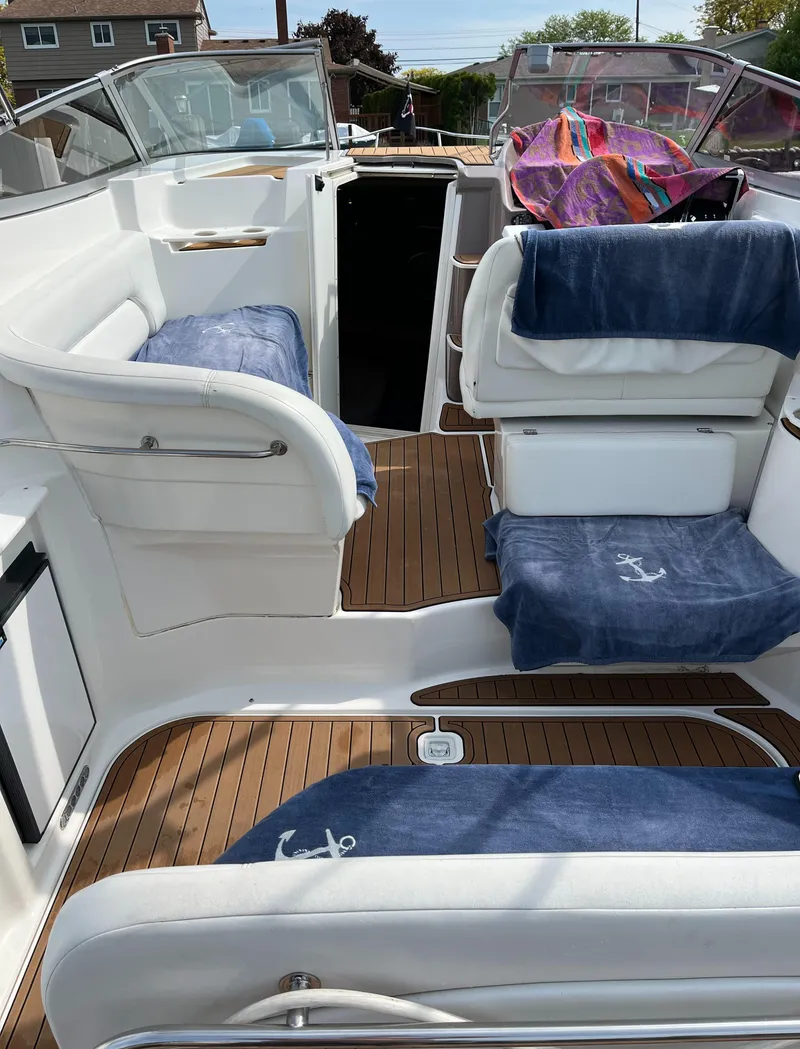 Slide: The Image of 2003 Regal Commodore 2860 boat interior with blue seat covers and wooden flooring. - 6