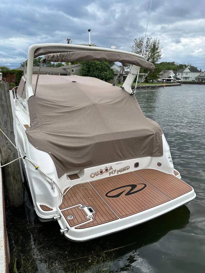 Slide: The Image of 2003 Regal Commodore 2860 boat docked with cover on, rear view. - 7