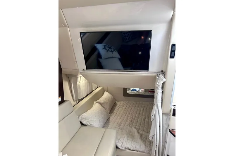 Slide: The Image of Interior of 2018 Regal 35 Sport Coupe with TV and cozy sleeping area. - 11