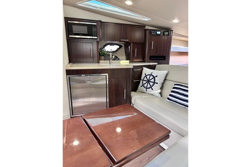 Slide: The Image of Luxurious interior of 2018 Regal 35 Sport Coupe with modern kitchenette and cozy seating. - 12