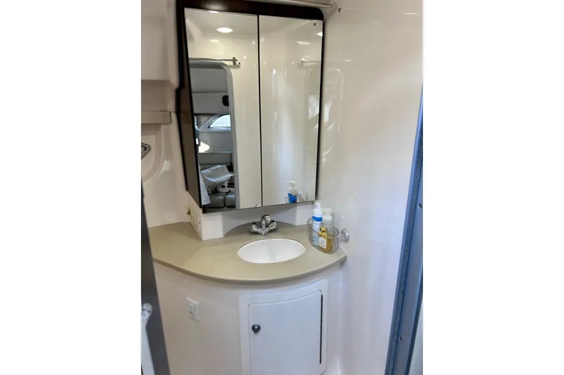 Slide: The Image of Bathroom vanity in 2018 Regal 35 Sport Coupe with mirror and sink. - 13