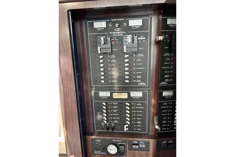 Slide: The Image of Control panel of a 2018 Regal 35 Sport Coupe boat, featuring various switches and indicators. - 14