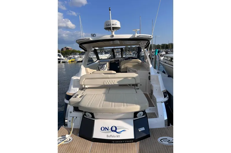 Slide: The Image of 2018 Regal 35 Sport Coupe yacht docked at marina, featuring spacious seating and modern design. - 2