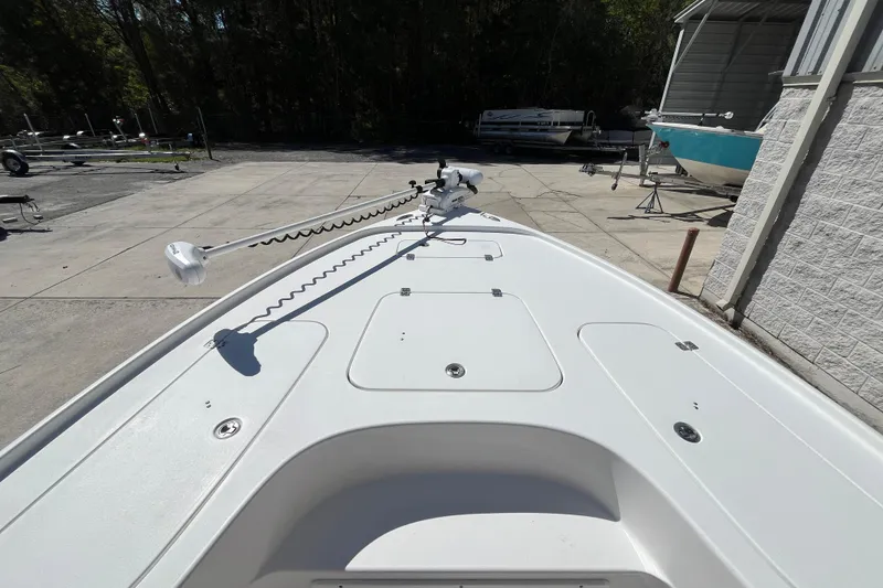 Slide: The Image of 2019 Sea Hunt BX 22 BR boat deck with trolling motor in a marina setting. - 11