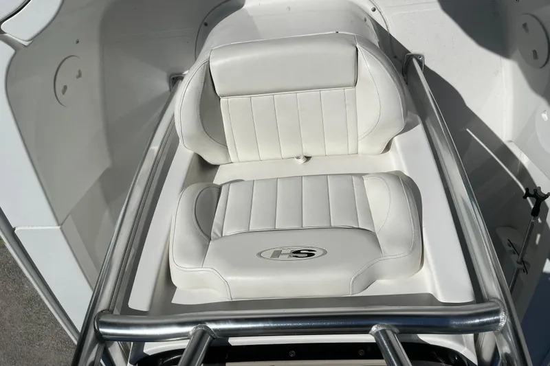 Slide: The Image of 2019 Sea Hunt BX 22 BR boat with white cushioned seating and stainless steel railing. - 12