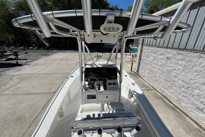 Slide: The Image of 2019 Sea Hunt BX 22 BR boat with T-top and console, parked outdoors. - 16
