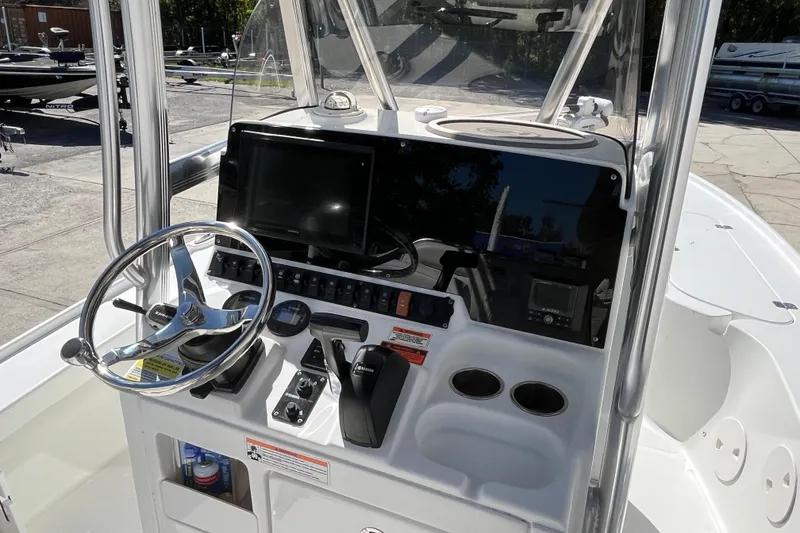 Slide: The Image of 2019 Sea Hunt BX 22 BR boat console with steering wheel and navigation controls. - 17