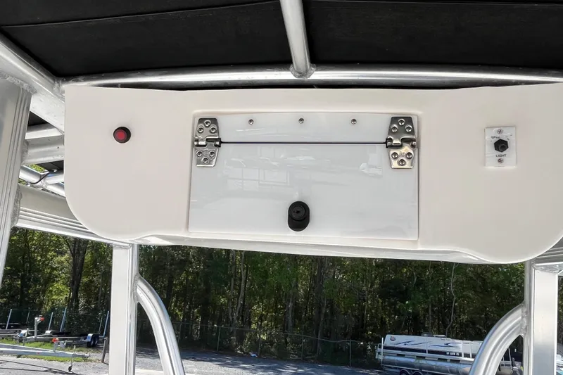Slide: The Image of 2019 Sea Hunt BX 22 BR boat console with storage compartment and control switches. - 18