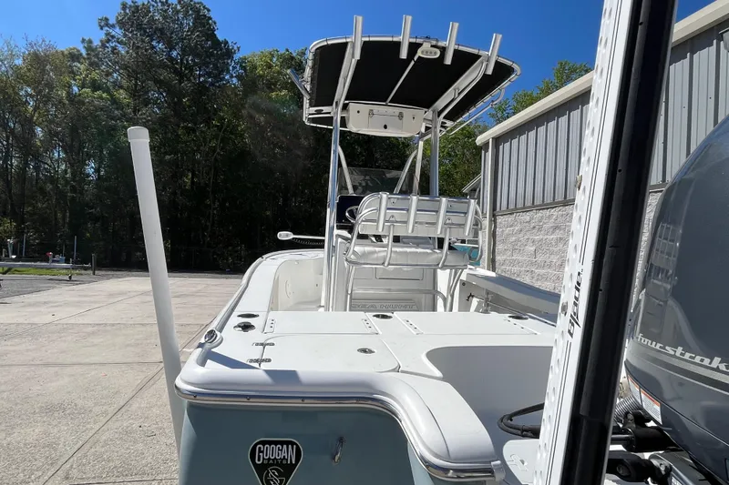 Slide: The Image of 2019 Sea Hunt BX 22 BR boat with T-top and outboard motor, parked outdoors. - 22