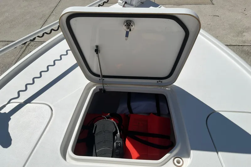 Slide: The Image of Open storage compartment on 2019 Sea Hunt BX 22 BR boat, containing life jackets and gear. - 28