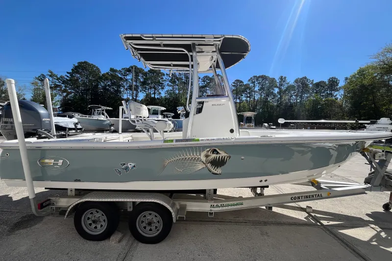 Slide: The Image of 2019 Sea Hunt BX 22 BR boat on trailer, featuring a sleek design and fish graphics. - 5