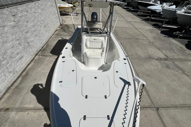 Slide: The Image of 2019 Sea Hunt BX 22 BR boat on concrete lot, featuring spacious deck and seating. - 9