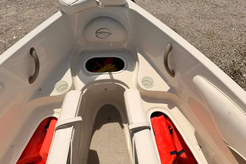 Slide: The Image of Interior of a 2004 Crownline 180 BR boat with seating and storage compartments. - 11