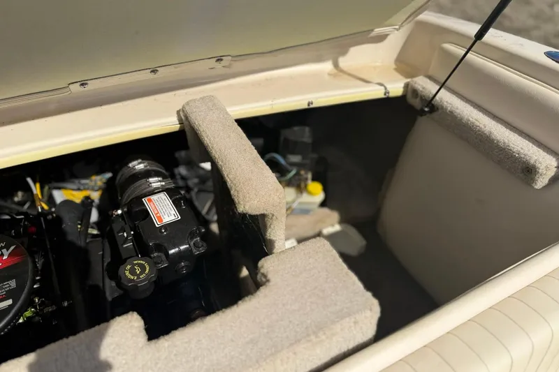 Slide: The Image of Engine compartment of a 2004 Crownline 180 BR boat, showcasing mechanical components. - 14