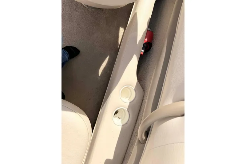 Slide: The Image of Interior of a 2004 Crownline 180 BR boat showing cup holders and seating area. - 6