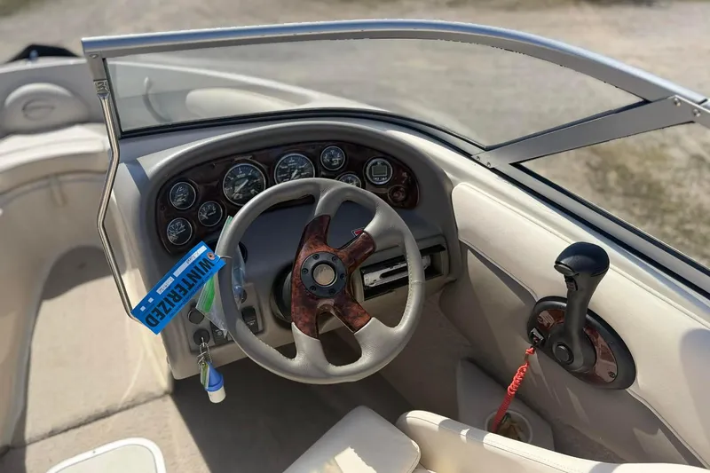 Slide: The Image of 2004 Crownline 180 BR boat dashboard with steering wheel and control panel. - 7