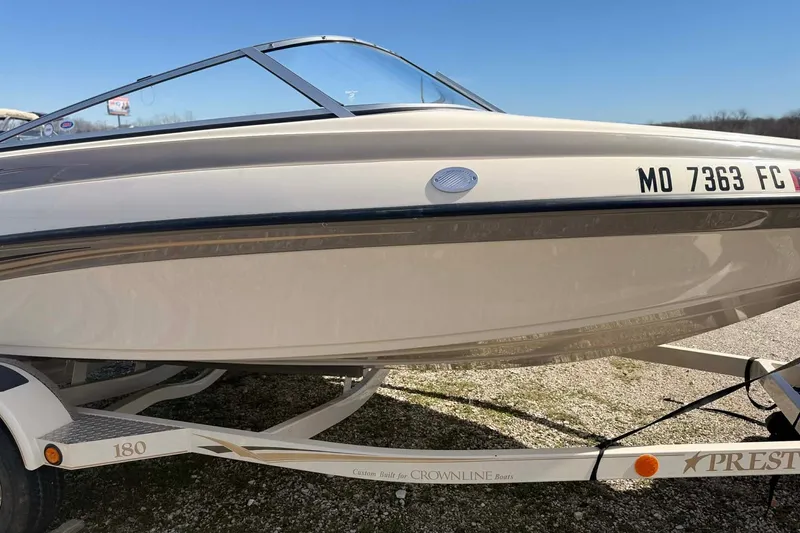 Slide: The Image of 2004 Crownline 180 BR boat on trailer, side view, sunny day. - 9