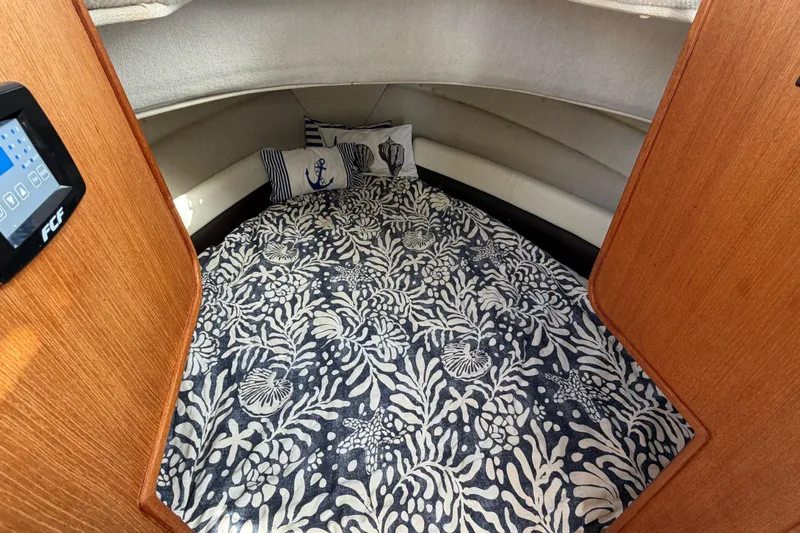 Slide: The Image of Cozy cabin interior of 2017 Ranger Tugs R-27 with nautical-themed bedding. - 15