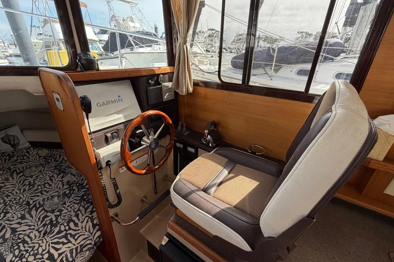 Slide: The Image of Interior of 2017 Ranger Tugs R-27 boat with Garmin navigation system and captain's chair. - 16
