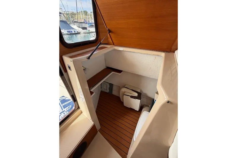 Slide: The Image of Interior cabin of 2017 Ranger Tugs R-27 boat with wooden flooring and window view. - 20
