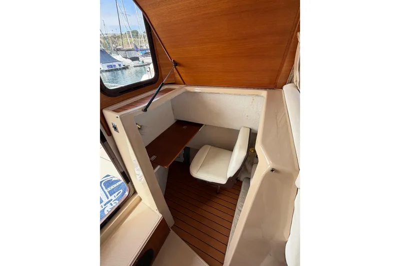 Slide: The Image of 2017 Ranger Tugs R-27 cabin interior with seating and wooden accents. - 21