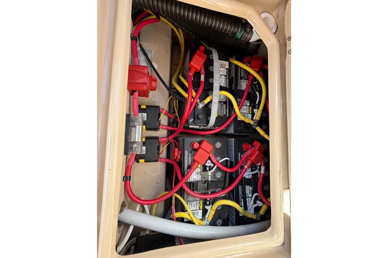 Slide: The Image of Battery compartment of a 2017 Ranger Tugs R-27 with red and yellow cables. - 26
